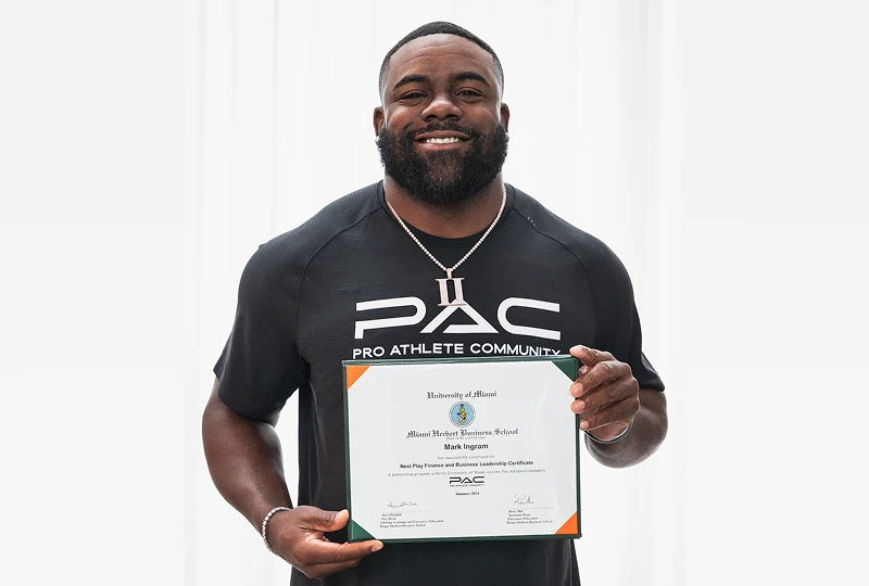 man poses with his PAC certificate