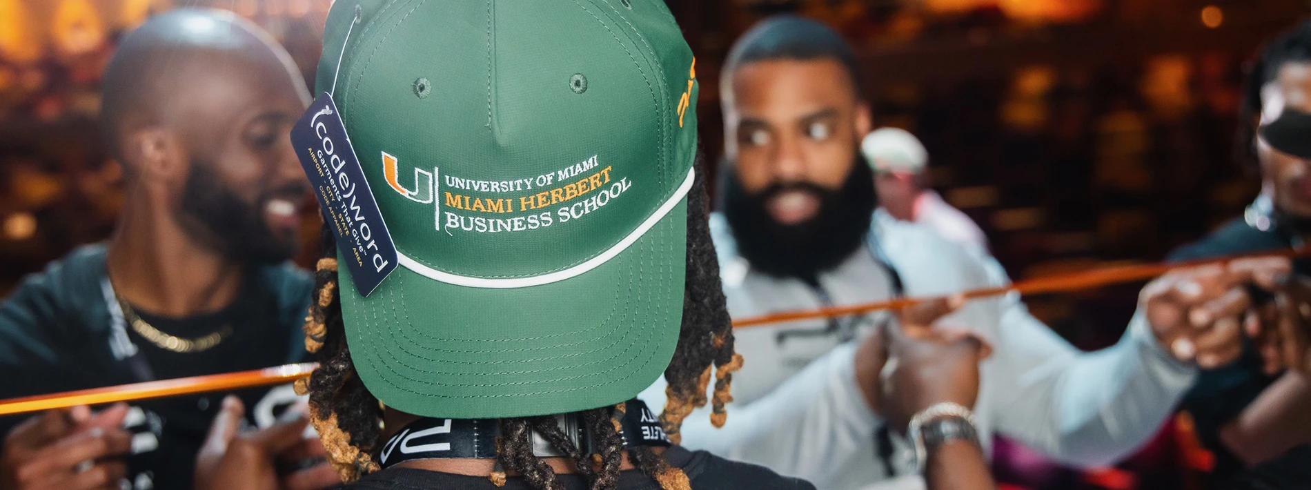 man with backwards UM hat at event